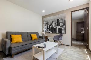 a living room with a couch and a table at OM 686 URBAN LOFTS Narvarte in Mexico City