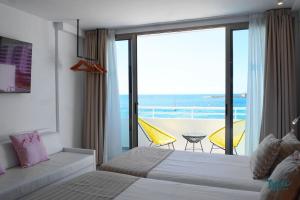 una camera con letto e vista sull'oceano di Typic Marina Playa - Adults Only a Baia di Sant'Antoni