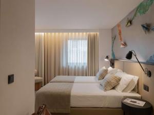 เตียงในห้องที่ ibis Styles Lisboa Aeroporto