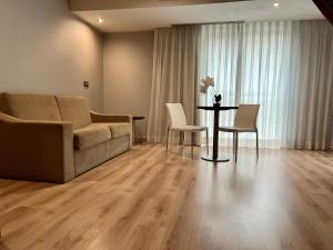 a living room with a couch and a table and chairs at Turia Granada in Granada