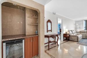 a kitchen and living room with a couch and a table at 2 Bedrooms Unit OceanFront Resort The Alexander in Miami Beach