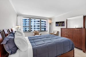 a bedroom with a large bed and a window at 2 Bedrooms Unit OceanFront Resort The Alexander in Miami Beach