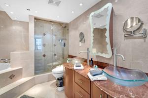 a bathroom with a sink and a toilet and a shower at 2 Bedrooms Unit OceanFront Resort The Alexander in Miami Beach