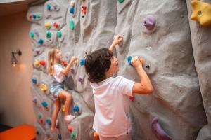 two children climbing on a rock wall at Mandarin Oriental, Costa Navarino in Pylos