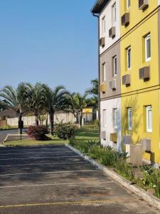 an empty parking lot next to a yellow building at SUN1 Durban in Durban