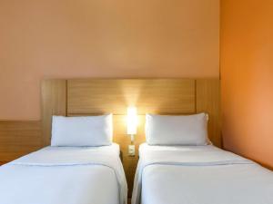 duas camas sentadas uma ao lado da outra num quarto em ibis Strasbourg Centre Historique em Estrasburgo