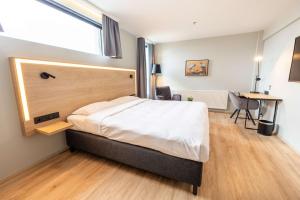 a bedroom with a large bed and a desk at Park Inn by Radisson Reykjavik Keflavík Airport in Keflavík