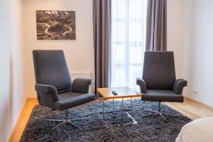 two chairs and a coffee table in a room at Park Inn by Radisson Reykjavik Keflavík Airport in Keflavík