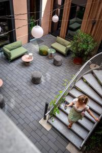 a little girl playing with a toy on some stairs at Hôtel Tandem - Boutique Hôtel in Strasbourg