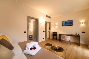 a bedroom with a bed and a desk and a table at Hotel Villa Cuserina in Cannobio