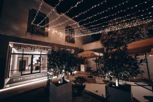 a building with lights and potted plants in front of it at Ananea Tropea Yachting Resort in Tropea