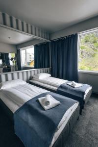 Gulta vai gultas numurā naktsmītnē Live Lofoten Hotel