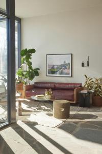 a living room with a brown couch and a table at ROOST Kelly Drive in Philadelphia