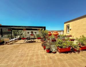 a patio with potted plants on the side of a building at B&B Pellicano Guest House in Reggio di Calabria