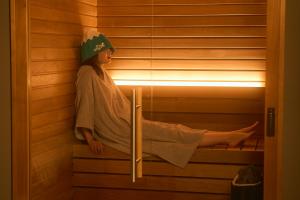 a young girl sitting in a sauna at Mt Fuji View and Private Sauna Ryokan Shizuku in Yamanakako