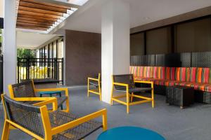 a waiting area with colorful chairs and tables at Home2 Suites By Hilton Gainesville in Gainesville