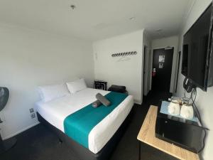 a hotel room with a bed with a brown object on it at No. 9 Hotel in Auckland