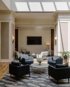 a living room with couches and a flat screen tv at Club Quarters Hotel Rittenhouse Square, Philadelphia in Philadelphia