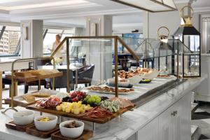 a buffet with many different types of food on a counter at The Langham, Boston in Boston