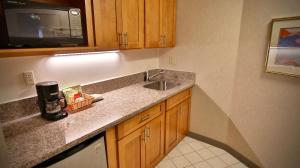 a kitchen with a sink and a microwave at Aston at the Executive Centre Hotel in Honolulu