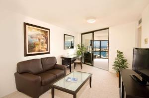 a living room with a couch and a table at Aston at the Executive Centre Hotel in Honolulu