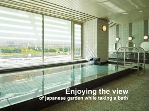 a swimming pool in a building with the wordsemploying the view of japan at Mitsui Garden Hotel Kyoto Shijo in Kyoto