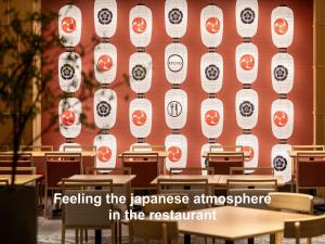 a wall with tables and chairs in a restaurant at Mitsui Garden Hotel Kyoto Shijo in Kyoto