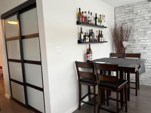 a dining room with a table and some bottles of wine at Vancouver Airport Cozy room 舒适小屋, Richmond,near YVR in Richmond