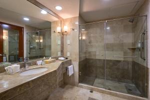 a bathroom with a sink and a glass shower at Holiday Inn Tuxtla Gutierrez, an IHG Hotel in Tuxtla Gutiérrez