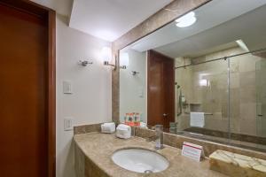 a bathroom with a sink and a large mirror at Holiday Inn Tuxtla Gutierrez, an IHG Hotel in Tuxtla Gutiérrez