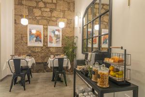 a restaurant with a table with food on it at Hotel The Cathedral Vegueta in Las Palmas de Gran Canaria