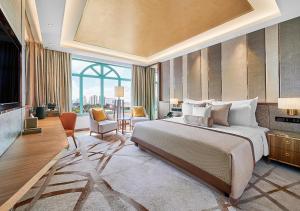 a bedroom with a large bed and a large window at Sunway Resort Hotel in Kuala Lumpur