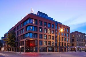 a large red brick building on a city street at Virgin Hotels London - Shoreditch in London