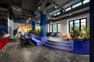 a lobby of a office with plants at CX Milan Bicocca in Milan