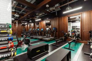 a gym with a lot of treadmills and ellipticals at Virgin Hotels London - Shoreditch in London