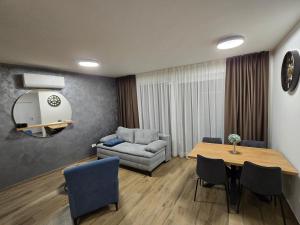 a living room with a table and a couch at Apartman AURA self CHECK-IN, FREE PRIVATE PARKING in Osijek