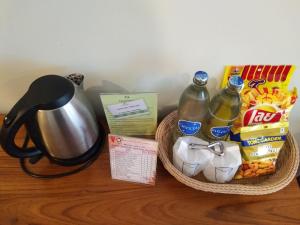 a table with a basket of food and a kettle at Princess River Kwai Hotel in Kanchanaburi City