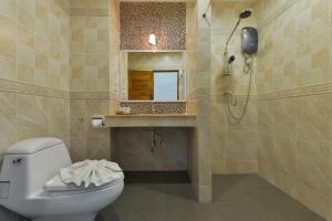 a bathroom with a toilet and a sink and a mirror at Princess River Kwai Hotel in Kanchanaburi City