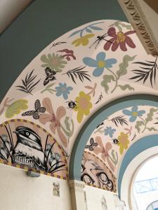 a ceiling with flowers and insects painted on it at Ibis Styles Strasbourg Centre République in Strasbourg