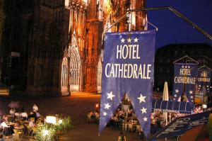 a flag is hanging in front of a building at Hotel Cathédrale in Strasbourg