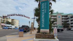 a sign on the side of a street next to a parking lot at Boardwalk Inn and Suites in Daytona Beach