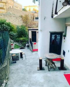 a patio with two benches and a building at Ci Thorno Hotel in Crosia