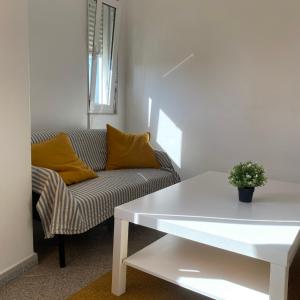 a living room with a couch and a table at Lisbon Airport Guesthouse in Lisbon