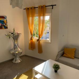 a living room with a couch and a window at Lisbon Airport Guesthouse in Lisbon