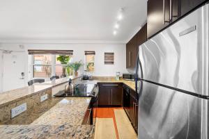 a large kitchen with a stainless steel refrigerator at South Beach Family & Pet Friendly with Free Parking in Miami Beach