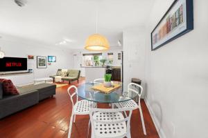 a living room with a glass table and chairs at South Beach Family & Pet Friendly with Free Parking in Miami Beach