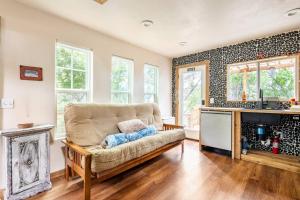 a living room with a couch and a fireplace at Cozy Coop Casita - Lake Travis-Hot Tub-Tiny House in Austin