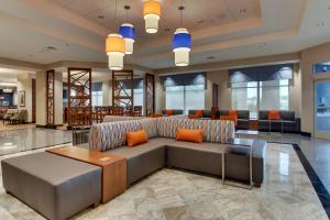 a living room with a couch and a table at Drury Inn & Suites Knoxville West in Knoxville