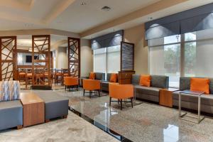 a lobby with couches and chairs and a bar at Drury Inn & Suites Knoxville West in Knoxville