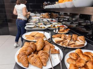 een buffet met croissants en gebak op borden bij B&B Sweet Sleep in Napels